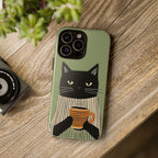 Phone case with a cat design holding a cup on a wooden surface