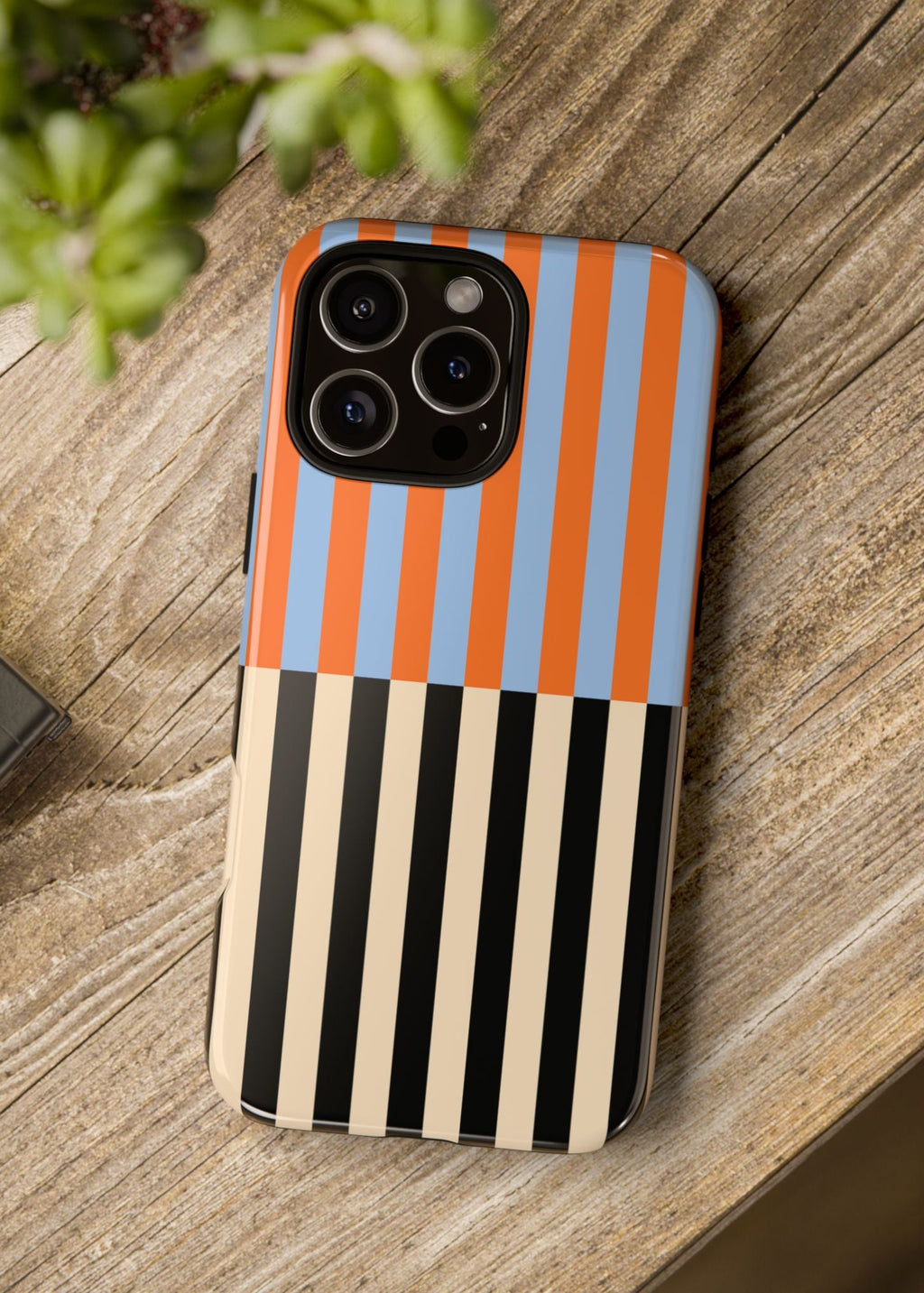 Phone case with striped pattern on a wooden surface