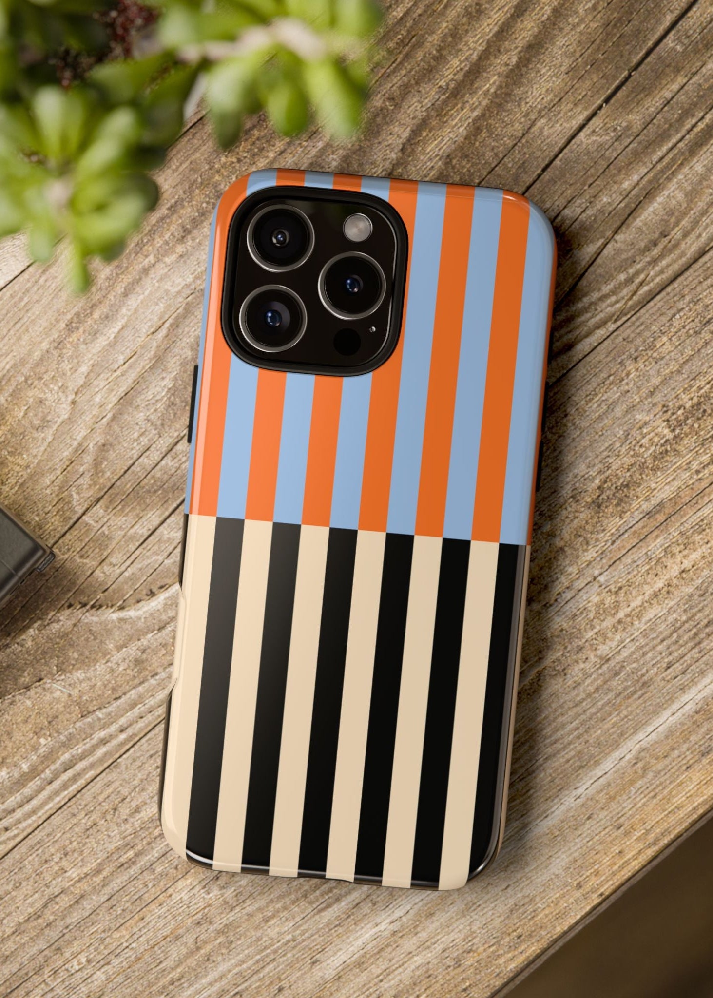 Phone case with striped pattern on a wooden surface