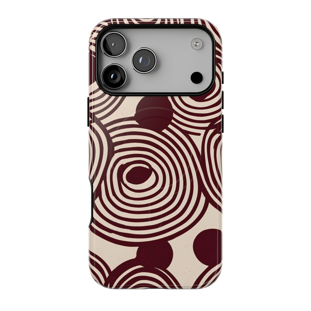 Retrograde protective MagSafe case featuring oversized burgundy and cream concentric circles, abstract swirls, and a distressed 70s-inspired geometric pattern.