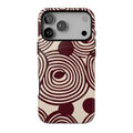 Retrograde protective MagSafe case featuring oversized burgundy and cream concentric circles, abstract swirls, and a distressed 70s-inspired geometric pattern.