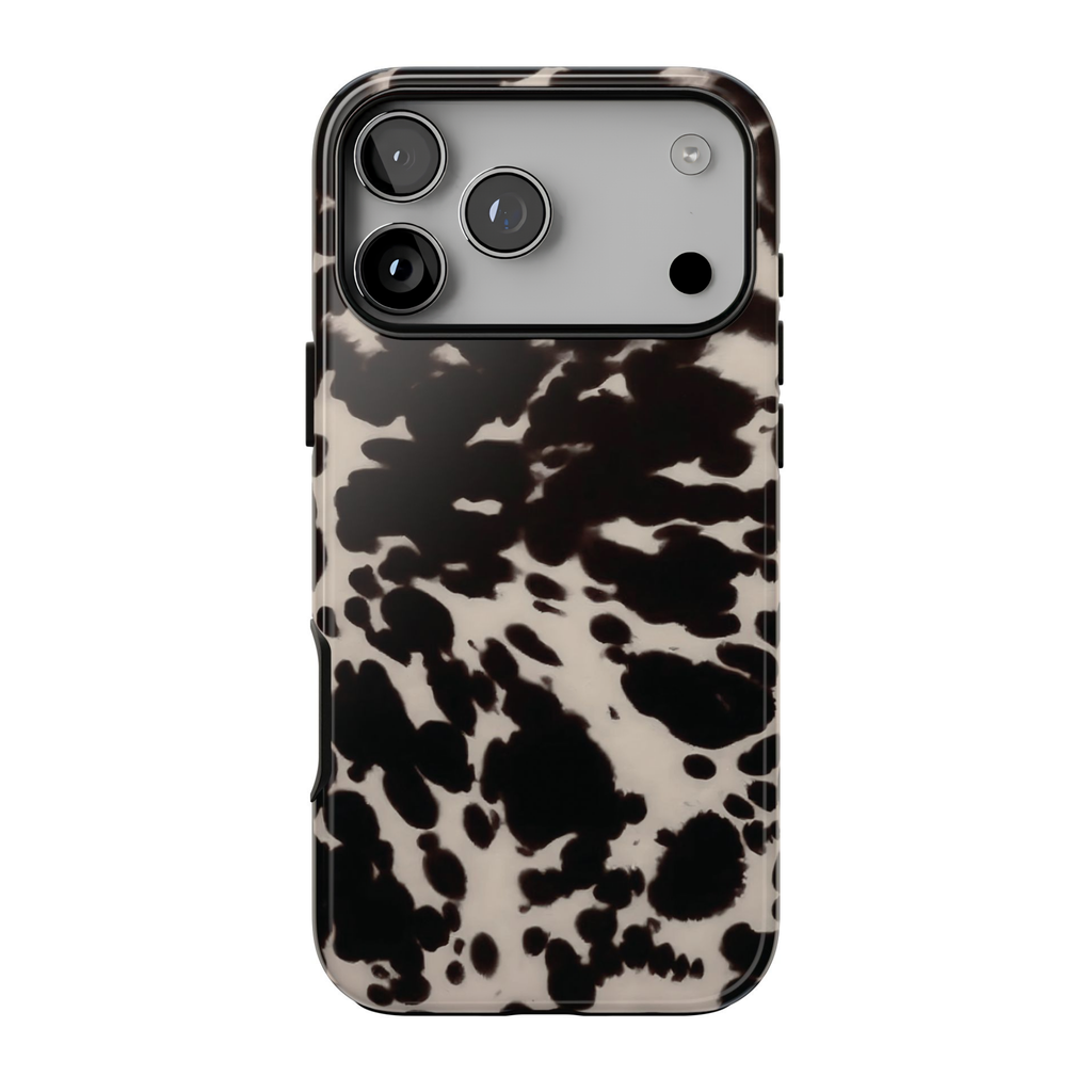 Spotted Cutie phone case featuring a bold black and cream cow print pattern with a trendy western-inspired aesthetic.