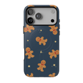 Gingerbread Dreams MagSafe iPhone case featuring smiling gingerbread cookies and scattered golden stars on a deep navy blue background with a whimsical Christmas pattern.