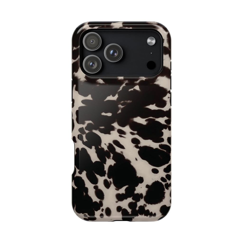 Phone case with a black and white cow print pattern on a white background